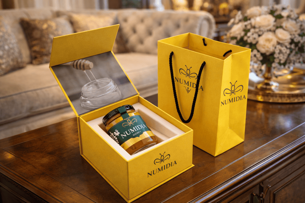 Luxury Numidia gift box and branded bag on wooden table in elegant living room, premium natural gift set