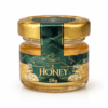 Numidia 28g mini jar of premium British honey displayed on a clean white background with gold lid and green floral label.