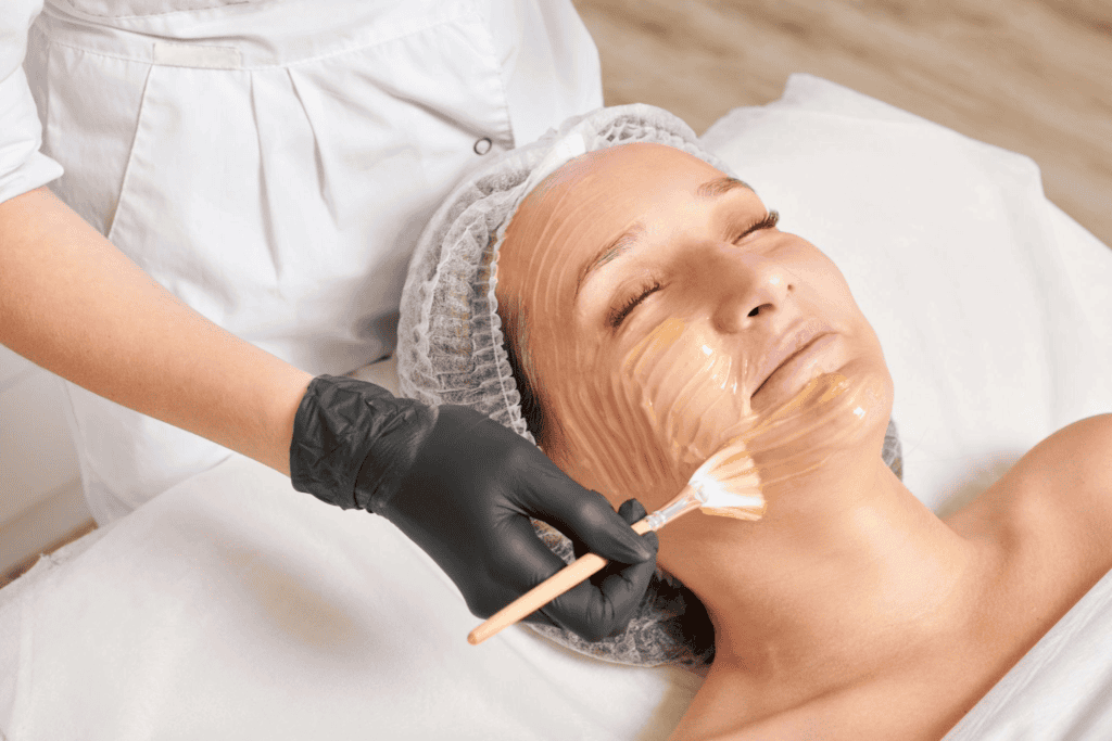 woman applying British honey mask on face