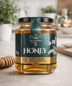 Numidia Honey 340g jar of Lancashire local raw British honey on a kitchen countertop